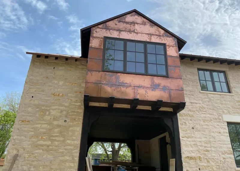 Copper metal panel facade on a stone building for Skylight Installation in Covina